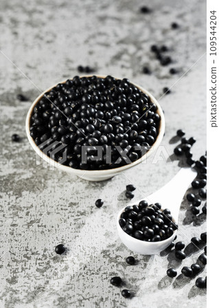 Black beans on gray background Black beans on gray background 109544204