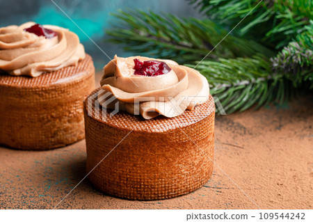 Cakes filled with cream and cherry jam. Box eclairs. New Year and holiday concept. Cakes filled with cream and cherry jam. Box eclairs. New Year and holiday concept. 109544242