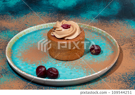 Cakes filled with cream and cherry jam. Box eclairs. New Year and holiday concept. 109544251