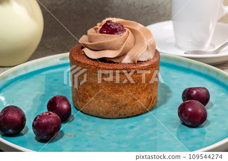 Cakes filled with cream and cherry jam. Box eclairs. New Year and holiday concept. Cakes filled with cream and cherry jam. Box eclairs. New Year and holiday concept. 109544274