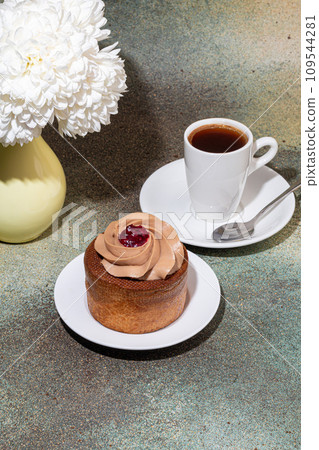 Cakes filled with cream and cherry jam. Box eclairs. New Year and holiday concept. 109544281