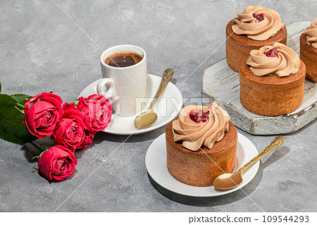 Cakes filled with cream and cherry jam. Box eclairs. New Year and holiday concept. Cakes filled with cream and cherry jam. Box eclairs. New Year and holiday concept. 109544293