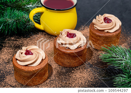 Cakes filled with cream and cherry jam. Box eclairs. New Year and holiday concept. Cakes filled with cream and cherry jam. Box eclairs. New Year and holiday concept. 109544297