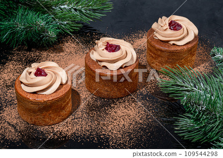 Cakes filled with cream and cherry jam. Box eclairs. New Year and holiday concept. 109544298