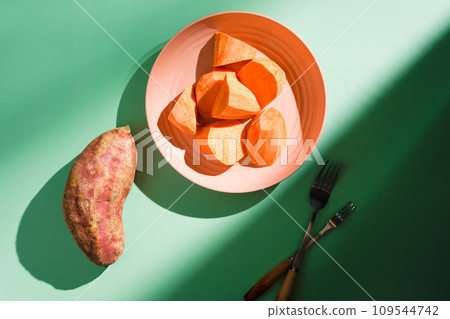 Sweet potatoes on colorful background plate 109544742