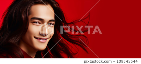 Elegant handsome smiling young Asian man with long hair, on red background, banner, copy space 109545544