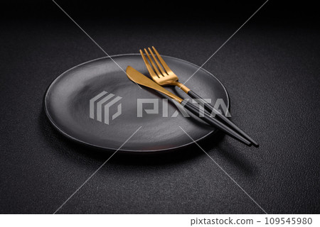 Bumpy empty ceramic plate on a textured concrete background 109545980