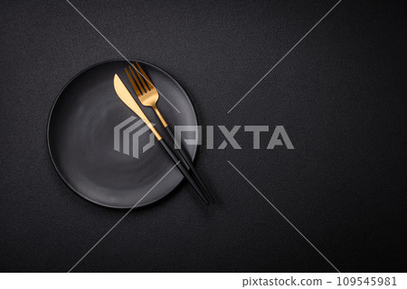 Bumpy empty ceramic plate on a textured concrete background 109545981