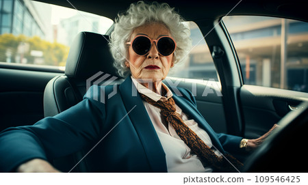 Beautiful old lady driving a car. An elderly confident woman drives a car. 109546425