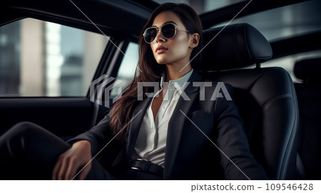 Beautiful young businesswoman sitting on the back seat of the car. Beautiful young businesswoman sitting on the back seat of the car. 109546428