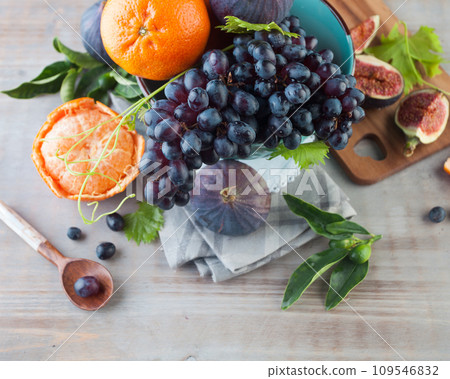 Fruit market. Orange tangerine, figs and grape fruit mix on grey wood top view.  109546832