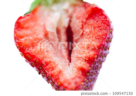 Ripe half of a strawberry on a white background. Ripe half of a strawberry on a white background. 109547130