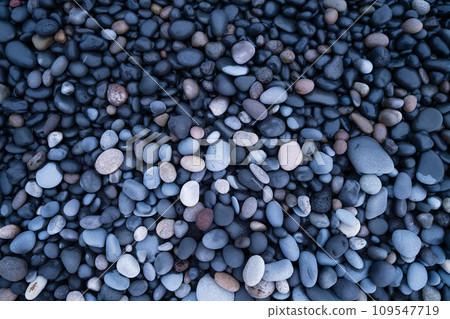 Gray pebbles as a background. Round stones on the beach. Photography for design. Gray pebbles as a background. Round stones on the beach. Photography for design. 109547719