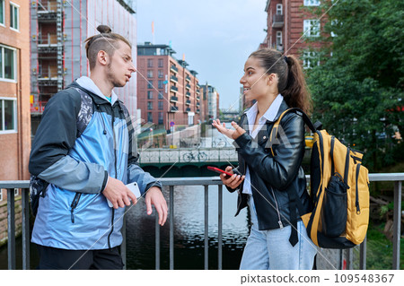 Outdoor meeting of two teenage students, guy and girl, modern city background 109548367