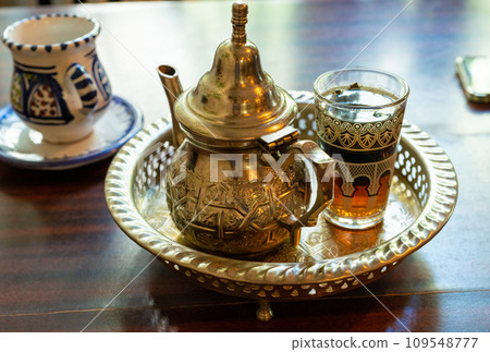 Moroccan Mint Tea in Teapot and Glass Moroccan Mint Tea in Teapot and Glass 109548777