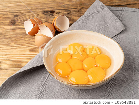 Egg Yolks in Bowl, Fresh Chicken Egg Yolk Separated from Whites for Cooking Recipe, Organic Yolks Top View 109548881