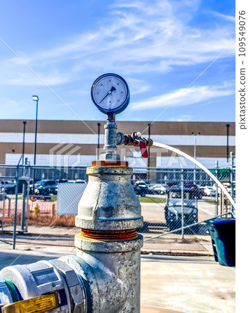 soil vapor extraction test well header with pressure gauge and sample line. soil vapor extraction test well header with pressure gauge and sample line. 109549076