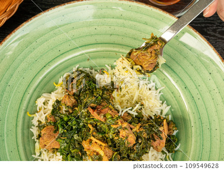 Pilau on Green Plate, Beef Pilaf, Traditional Asian Dish Plov also known as Polow, Pilav, Pallao, Pulao, Palaw Pilau on Green Plate, Beef Pilaf, Traditional Asian Dish Plov also known as Polow, Pilav, Pallao, Pulao, Palaw 109549628