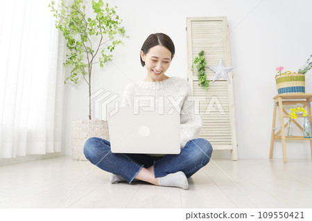 中年婦女在家使用筆記型電腦，全身 109550421