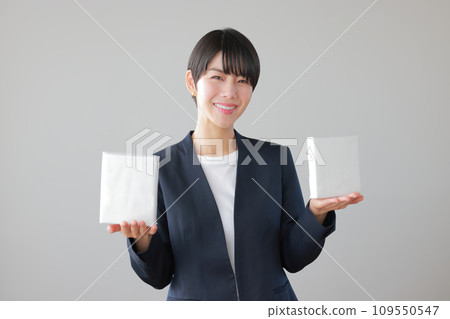 A smiling woman holding two boxes in her palms 1 A smiling woman holding two boxes in her palms 1 109550547