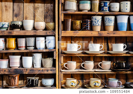 Various pottery ceramic displayed on wooden shelves at store. pottery ceramic on wooden shelves Various pottery ceramic displayed on wooden shelves at store. pottery ceramic on wooden shelves 109551484