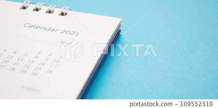calendar page 2021 close up on blue background business planning appointment meeting concept 109552310