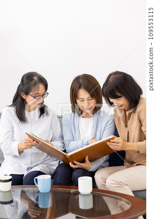 Three women watching the album 109553115
