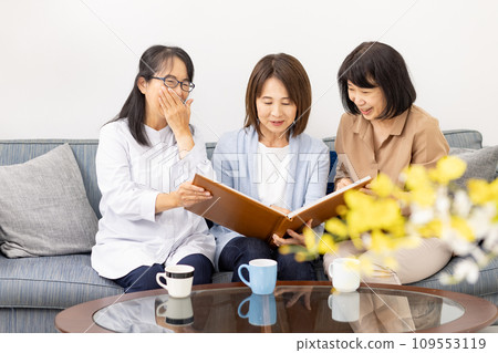 Three women watching the album 109553119