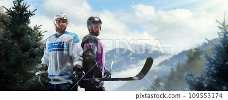 Hockey portrait. Two professional hockey players are standing on an outdoor skating rink in the forest. Outdoor hockey. Sports emotions. Sport concept Hockey portrait. Two professional hockey players are standing on an outdoor skating rink in the forest. Outdoor hockey. Sports emotions. Sport concept 109553174