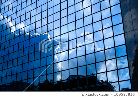 A blue sky reflected in the window of the building A blue sky reflected in the window of the building 109553936