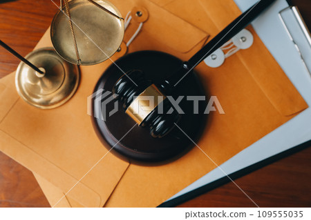 Business and lawyers discussing contract papers with brass scale on desk in office. Law, legal services, advice, justice and law concept picture with film grain effect Business and lawyers discussing contract papers with brass scale on desk in office. Law, legal services, advice, justice and law concept picture with film grain effect 109555035