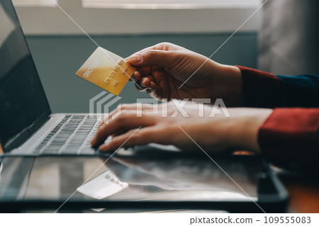 Close up of woman hand using credit card and laptop for payment and online shopping, Online shopping, payments digital banking, E-commerce concept. Close up of woman hand using credit card and laptop for payment and online shopping, Online shopping, payments digital banking, E-commerce concept. 109555083