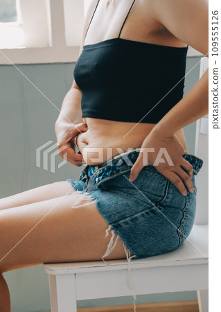fat woman, fat belly, chubby, obese woman hand holding excessive belly fat with measure tape, woman diet lifestyle concept 109555126