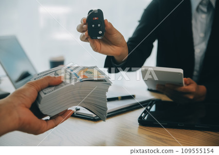 Salesman send key to customer after good deal agreement, successful car loan contract buying or selling new vehicle. 109555154