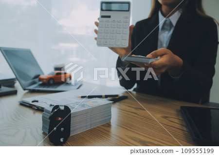 Salesman send key to customer after good deal agreement, successful car loan contract buying or selling new vehicle. Salesman send key to customer after good deal agreement, successful car loan contract buying or selling new vehicle. 109555199