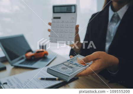 Salesman send key to customer after good deal agreement, successful car loan contract buying or selling new vehicle. Salesman send key to customer after good deal agreement, successful car loan contract buying or selling new vehicle. 109555200