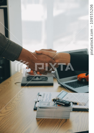 Salesman send key to customer after good deal agreement, successful car loan contract buying or selling new vehicle. Salesman send key to customer after good deal agreement, successful car loan contract buying or selling new vehicle. 109555206