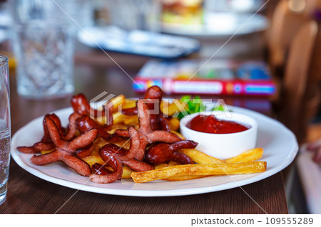 Delicious Children's Menu with Sausages, French Fries, and Ketchup in a Restaurant 109555289