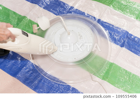 Parts cut of a senior woman cleaning lighting equipment 109555406