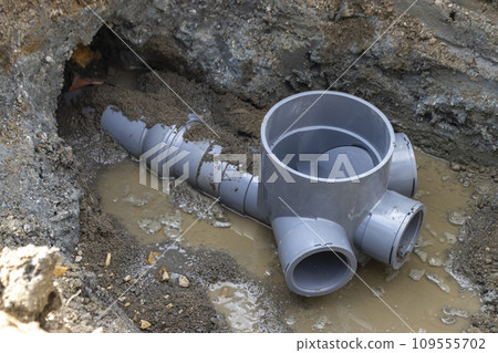 Plumbing work connecting residential drainage to the sewer system 109555702
