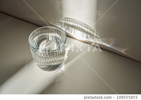 A glass of clean drinking water in the morning sun. A glass of clean drinking water in the morning sun. 109555855