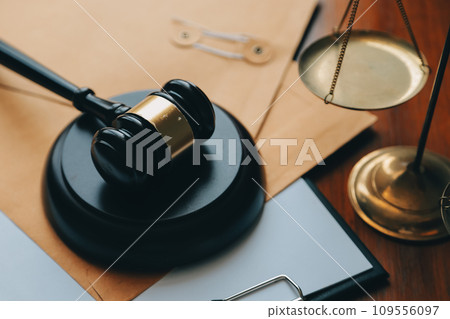 Business and lawyers discussing contract papers with brass scale on desk in office. Law, legal services, advice, justice and law concept picture with film grain effect 109556097