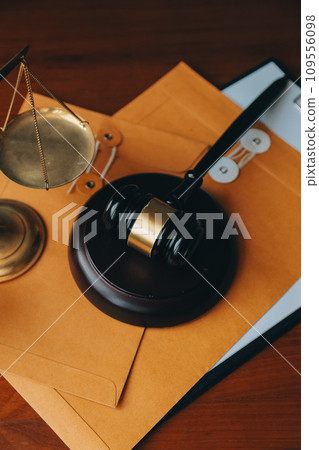 Business and lawyers discussing contract papers with brass scale on desk in office. Law, legal services, advice, justice and law concept picture with film grain effect 109556098