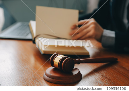 Business and lawyers discussing contract papers with brass scale on desk in office. Law, legal services, advice, justice and law concept picture with film grain effect 109556108