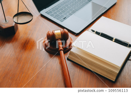Business and lawyers discussing contract papers with brass scale on desk in office. Law, legal services, advice, justice and law concept picture with film grain effect 109556113