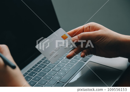 Women holding credit card and using smartphones at home.Online shopping, internet banking, store online, payment, spending money, e-commerce payment at the store, credit card, concept Women holding credit card and using smartphones at home.Online shopping, internet banking, store online, payment, spending money, e-commerce payment at the store, credit card, concept 109556153