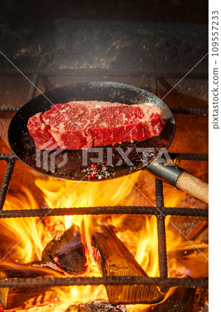Grill a steak over an outdoor Grill a steak over an outdoor 109557233