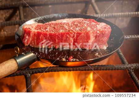 Grill a steak over an outdoor 109557234