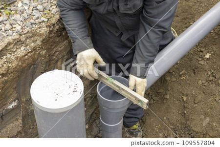 A person who performs plumbing work to connect residential drainage to the sewer system 109557804