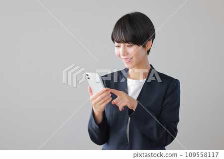 Business woman operating a smartphone 1 109558117